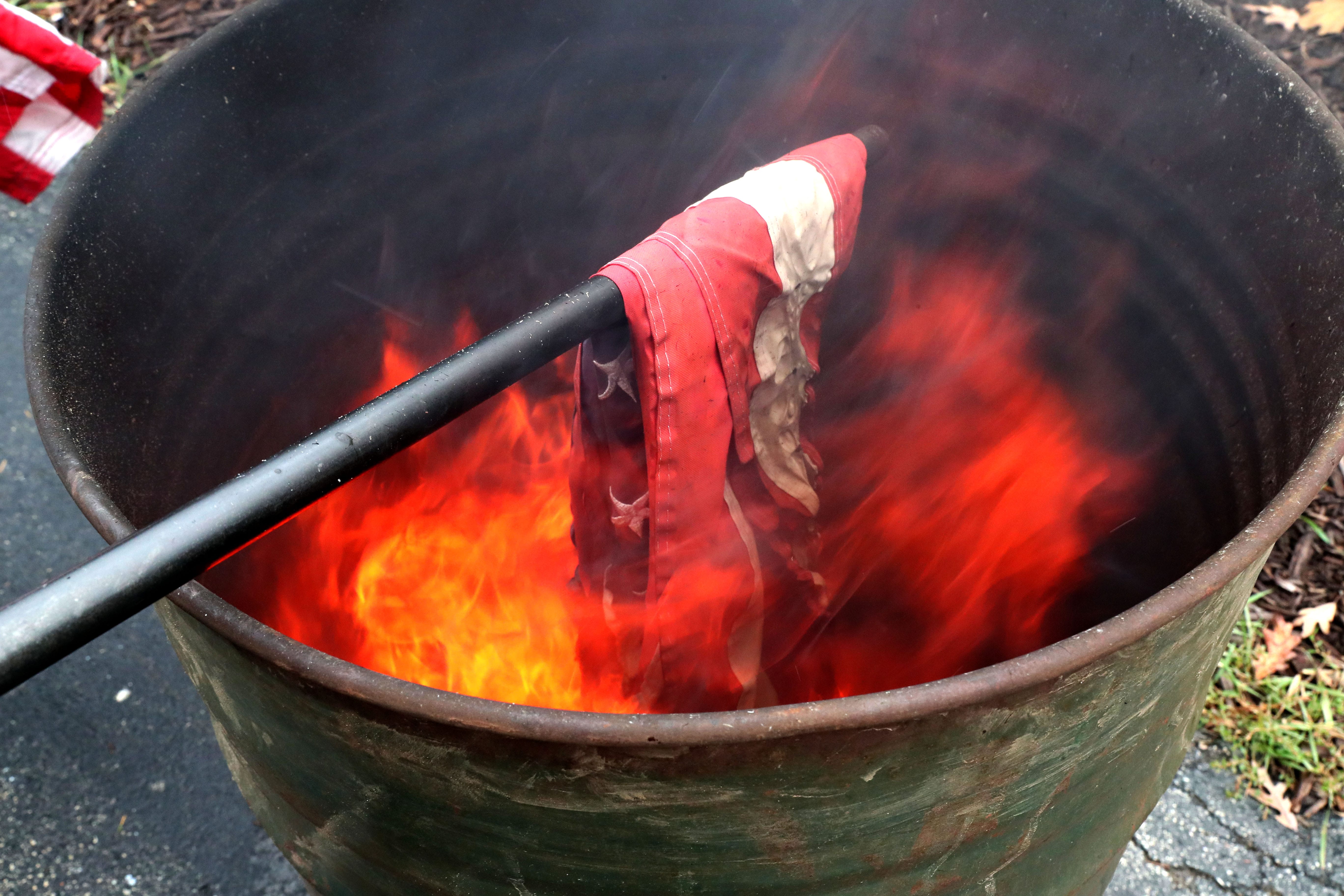 Here a flag to be retired is lowered into the flames.
Photo by Michael Sears/Milwaukee Journal Sentinel